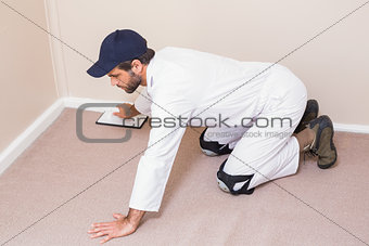 Handyman laying down a carpet