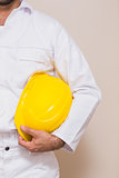 Handyman holding his yellow helmet