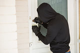 Burglar breaking open the door