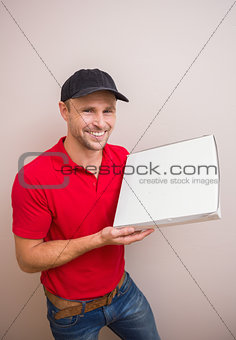 Happy delivery man holding pizza