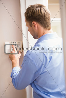 Man arming a home alarm