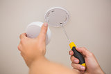 Handyman installing smoke detector