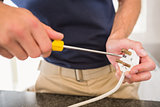 Electrician working at plug socket