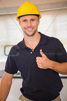 Smiling construction worker giving thumbs up