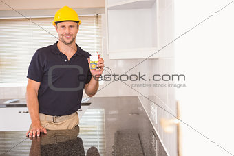 Construction worker showing a multimeter with cables