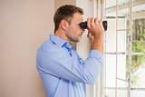 Man looking through a binoculars