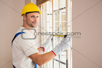 Construction worker using measuring tape