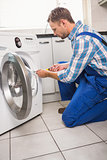 Handyman fixing a washing machine