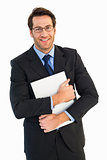 Smiling businessman holding his laptop looking at camera