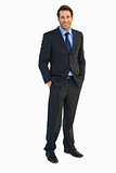Smiling young businessman with hands in pockets