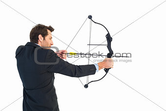 Businessman shooting bow and arrow