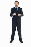 Businessman raising his clenched fists in front of him