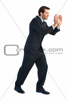 Handsome businessman pushing with hands