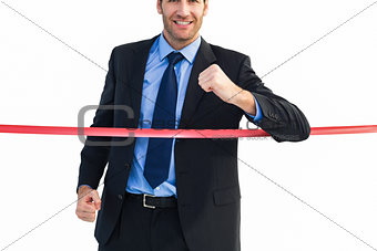 Happy businessman crossing finishing line