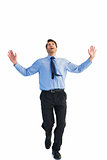 Happy businessman running with hands up