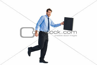 Walking and smiling businessman with suitcase