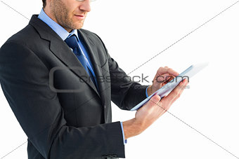 Mid section of a businessman using digital tablet