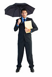 Businessman standing under umbrella while holding folder