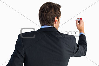 Rear view of businessman standing and writing