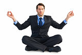 Calm businessman sitting in lotus pose
