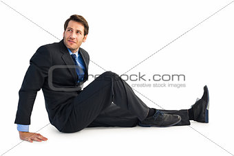 Businessman in suit sitting on floor