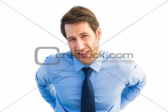 Handsome businessman with back pain standing