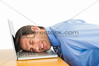 Businessman resting head on keyboard