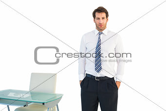 Businessman standing with hands in pockets