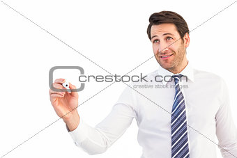 Smiling businessman writing with black marker