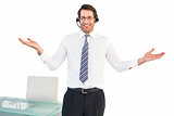 Smiling businessman presenting and wearing headphone