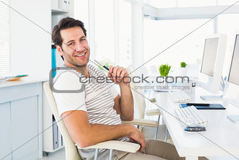 Casual young man with computer in a bright office