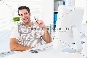 Smiling man with computer in a bright office