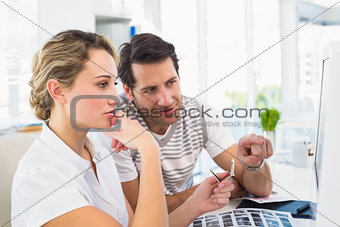 Photo editor pointing at the computer screen