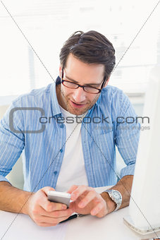 Male photo editor typing text message