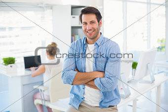 Portrait of handsome smiling photo editor with arms crossed