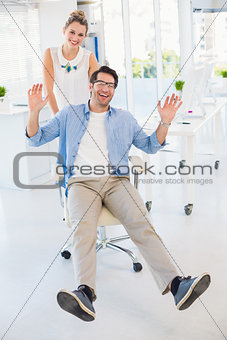 Man on swivel chair with hands up