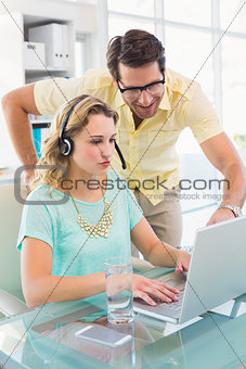 Pretty designer with headphone working on computer