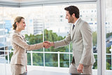 Two business workers shake hands
