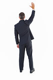 Rear view of a businessman in suit waving
