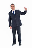 Smiling businessman posing with thumbs up