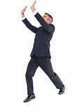 Businessman in suit with arms up