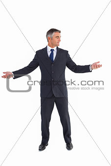 Businessman in suit spreading his arms