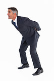 Businessman bending with arms on his back