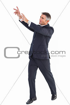 Happy businessman standing with arms up