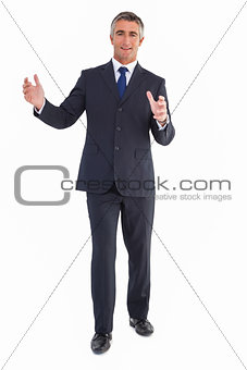 Smiling businessman standing with arms out