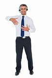 Businessman wearing headphone and doing gesture