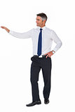 Smiling businessman with one arm out
