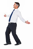 Side view of a businessman with arms out