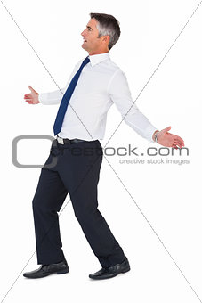 Side view of a businessman with arms out