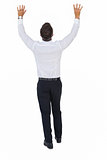 Rear view of a businessman with arms up